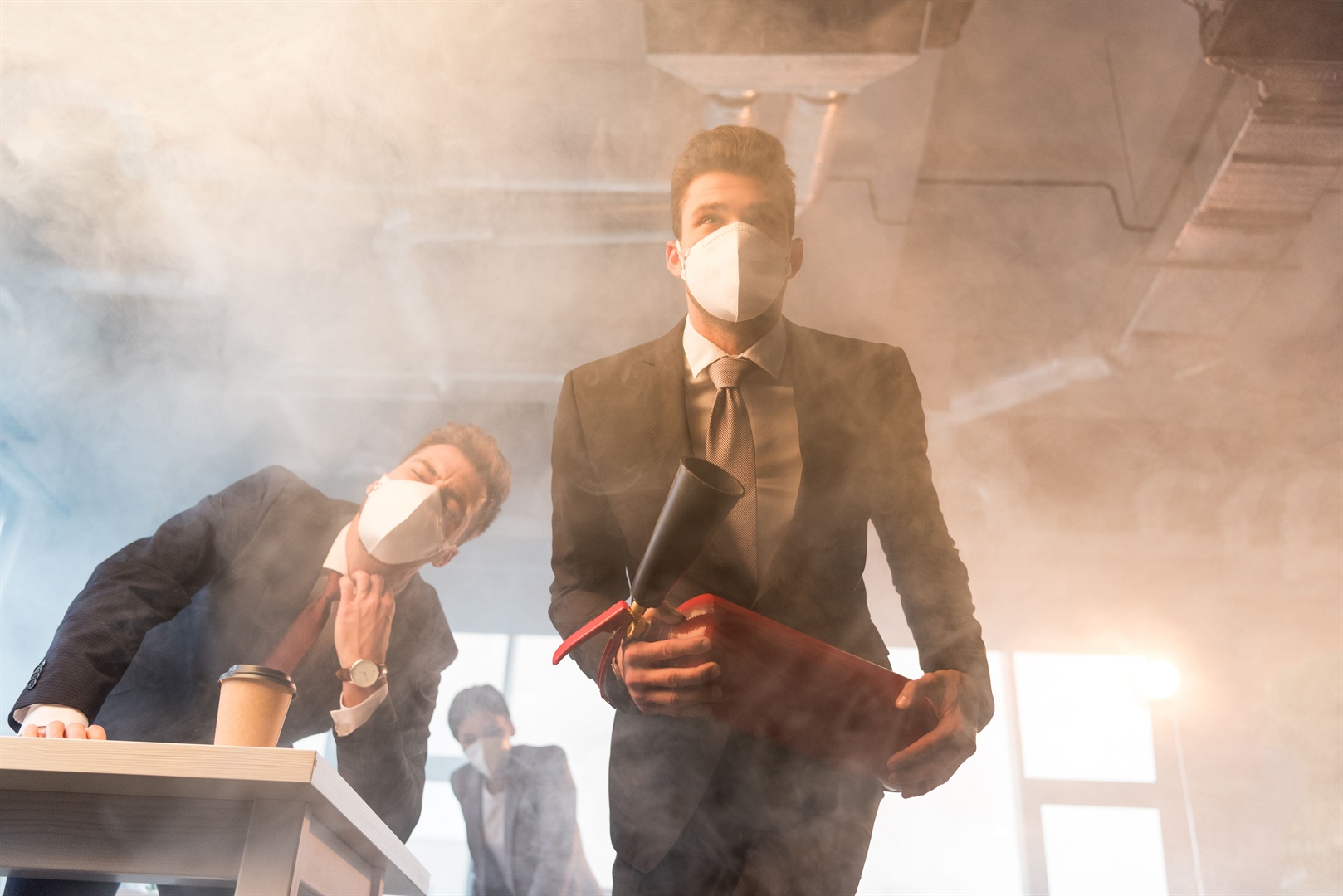 businessman-in-mask-holding-extinguisher