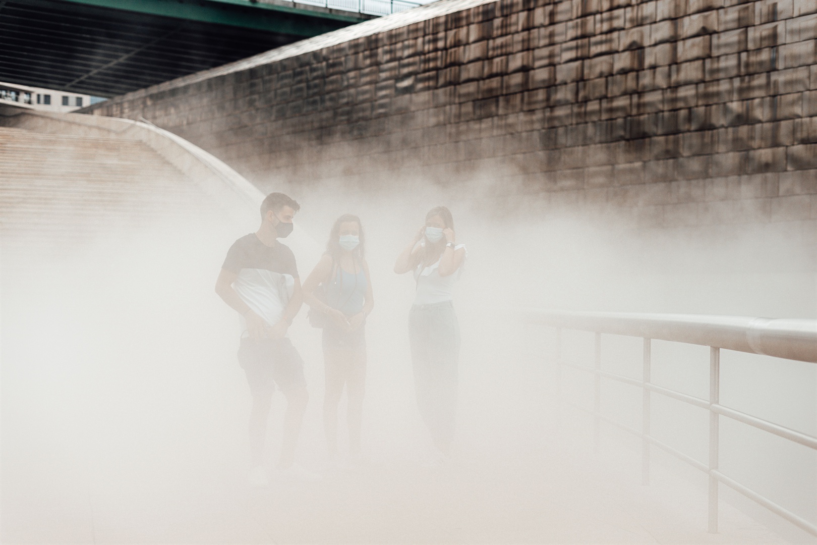 three-people-with-masks-on-a-pollution-cloud